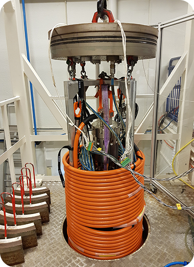 A Transmark Subsea pressure tank with orange cables around it.