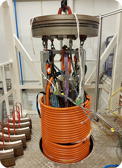 A Transmark Subsea pressure tank with orange cables around it. A Transmark Subsea pressure tank with orange cables around it.